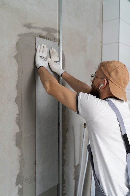 Tiler working on renovation of apartment