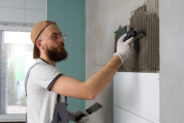 Tiler working on renovation of apartment